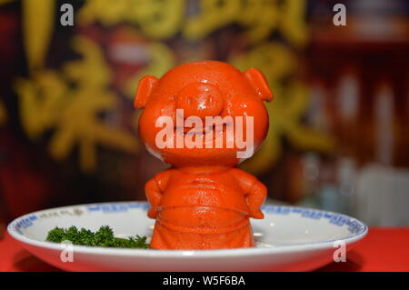 A piquant chafing dish seasoning featuring shape of pig is displayed during the 100th China Food and Drinks Fair in Chengdu city, southwest China's Si Stock Photo