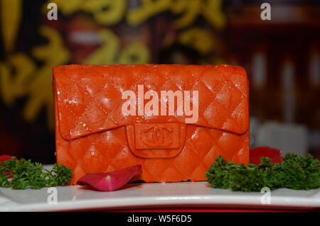 A piquant chafing dish seasoning featuring shape of Chanel handbag is displayed during the 100th China Food and Drinks Fair in Chengdu city, southwest Stock Photo