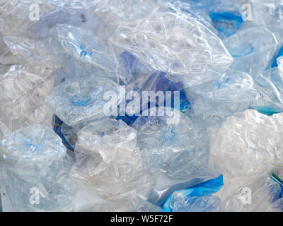 Water plastic bottles crushed and crumpled against background, Recycle waste management concept. Stock Photo