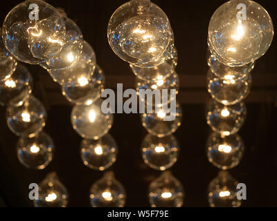Many light bulbs on the black scene. Lighting decor, vintage lamp, bulb decorative Stock Photo