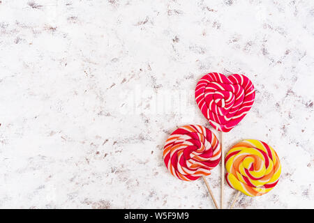 Colorful lollipops on white background. Top view Stock Photo