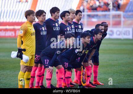 Players of the starting line-up of Japan's Kashima Antlers pose for photos before competing against China's Shandong Luneng in their Team E second rou Stock Photo