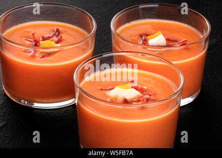 Salmorejo, Spanish cold tomato soup, in glasses, close-up on a black background Stock Photo