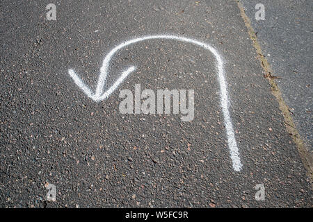 return arrow painted on tarmac Stock Photo