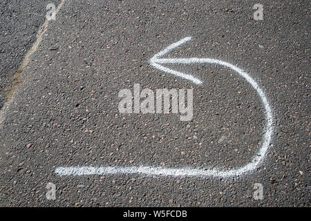return arrow painted on tarmac Stock Photo