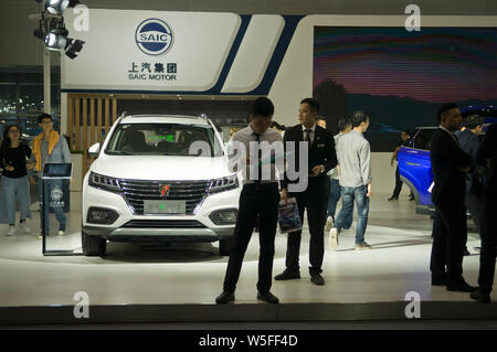--FILE--People visit the stand of Shanghai Automotive Industry Corporation (SAIC) during the 16th China (Guangzhou) International Automobile Exhibitio Stock Photo