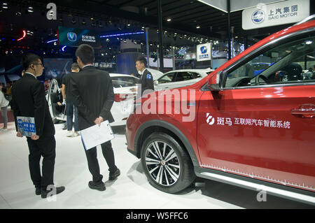 --FILE--People visit the stand of Shanghai Automotive Industry Corporation (SAIC) during the 16th China (Guangzhou) International Automobile Exhibitio Stock Photo