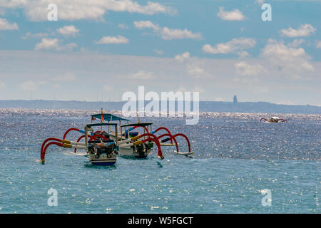 Sunrise view over tourists waiting for wild dolphin at Lovina beach in Bali, Indonesia. Stock Photo