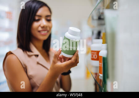 Focused photo on female hand that holding plastic bottle Stock Photo