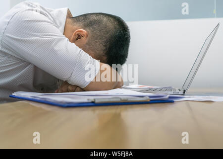 Exhausted businessman sleeping in the meeting room Stock Photo