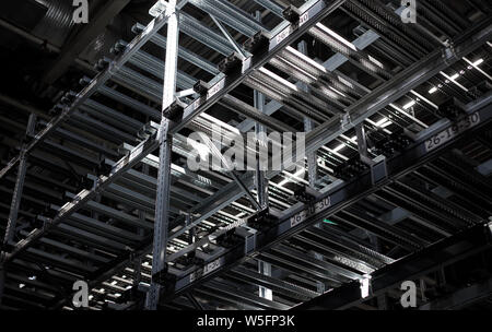 Rows of empty shelves in a big warehouse. Stock Photo