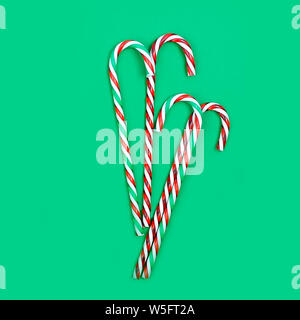 Christmas card or banner with candy sweets and gift box over the dark green background. top view, copy space, holiday concept, Christmas background Stock Photo