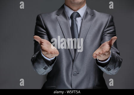 close up.businessman showing open palms.isolated on black background Stock Photo