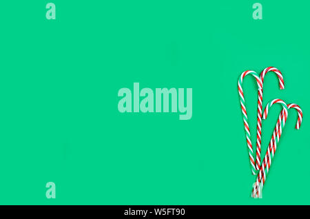 Christmas card or banner with candy sweets and gift box over the dark green background. top view, copy space, holiday concept, Christmas background Stock Photo