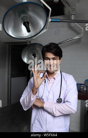 Male doctor showing ok sign and smiling Stock Photo