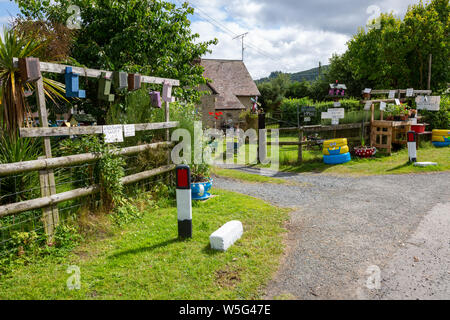 Entrance to a rural house, near Ludlow, Shropshire, UK, selling home made birdboxes and plants, with an honesty box. Stock Photo