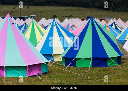 Large high end multi coloured glamping tents, at an outdoor festival UK Stock Photo