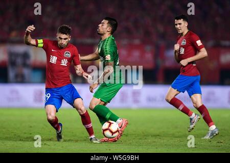Brazilian football player Olivio da Rosa, also known as Ivo, left, of Henan Jianye passes the ball against English football player Nico Yennaris, known in China as Li Ke, of Beijing Sinobo Guoan in their 20th round match during the 2019 Chinese Football Association Super League (CSL) in Zhengzhou city, central China's Henan province, 27 July 2019. Henan Jianye defeated Beijing Sinobo Guoan 1-0.