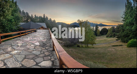Orange sky during sunset in Bariloche over mountains and lake Stock Photo