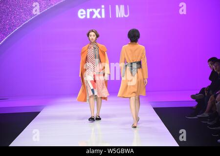 A model displays a new creation at the fashion show of City Fashion EngineÁHangzhou|erxi&MU by Li Yaheng&Zhang Qian during the China Fashion Week Fall Stock Photo