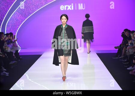 A model displays a new creation at the fashion show of City Fashion EngineÁHangzhou|erxi&MU by Li Yaheng&Zhang Qian during the China Fashion Week Fall Stock Photo