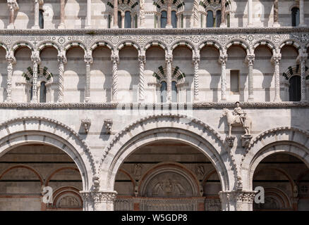 The facade of Lucca Cathedral, a Roman Catholic church dedicated to Saint Martin of Tours on Piazza San Martino. Stock Photo