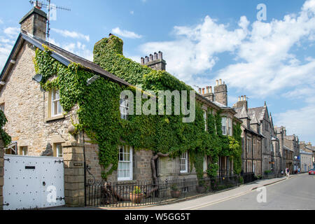 The Old Courts Building now a home  partially covered in Ivy, in Kirkby Lonsdale  a small town and civil parish in the South Lakeland district of Cumb Stock Photo