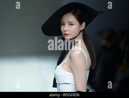 Chinese actress, host and model Shen Mengchen displays a new creation at the fashion show of GENIAL by Zhang Jinhao during the China Fashion Week Fall Stock Photo