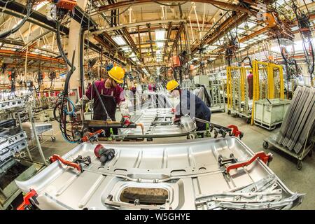 --FILE--Chinese workers assemble trucks on the assembly line at the ...