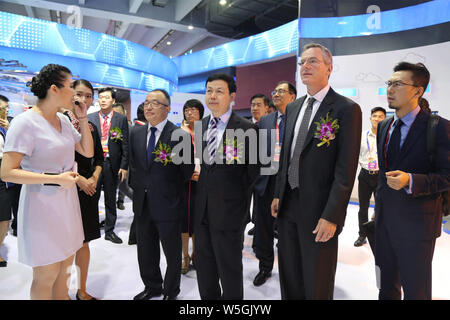 --FILE--Yang Jie, then Chairman and CEO of China Telecom Corporation, center, visits an exhibition in Guangzhou city, south China's Guangdong province Stock Photo