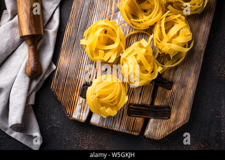 Raw pasta tagliatelle or fettuccine Stock Photo