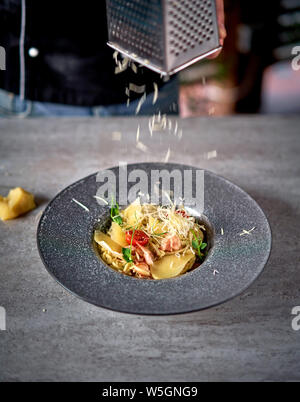 spaghetti sprinkled with grated cheese Stock Photo