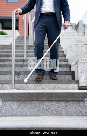 Close Up Of Blind Person Negotiating Steps Outdoors Using Cane Stock Photo