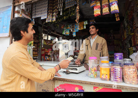 customer paying money to shopkeeper Stock Photo