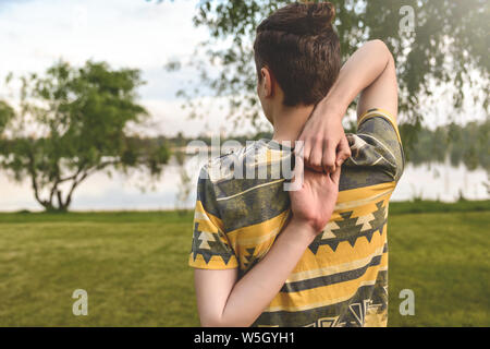 Man performing yoga young fitness man outdoor doing exercise Stock Photo