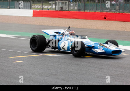 Sir Jackie Stewart driving in his 1969 championship-winning Matra MS80-02, down the International Straight,  at Silverstone Stock Photo