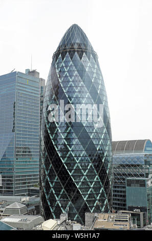 Vertical cityscape view of gherkin skyscraper building from The Garden at 120 on Fenchurch Street terrace in City of London England UK  KATHY DEWITT Stock Photo