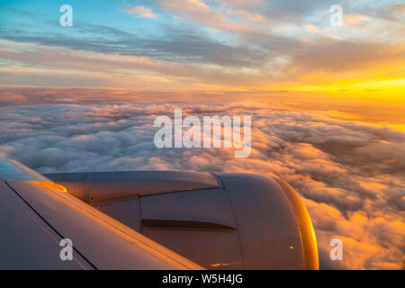 Generic view from airplane window of airplane wing and sunrise over England, United Kingdom, Europe Stock Photo
