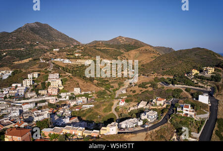 Aerial view of resort village Bali. Crete, Greece.  In the background are mountains and olive gardens under a blue sky. Stock Photo