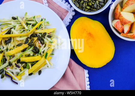 Fresh Healthy Summer Mango Fruit Salad With Apple Cabbage and Ginger Dressing Stock Photo