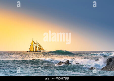 The schooner Anny owned by Rolf Munding under full sail sailing past Fistral in Newquay in Cornwall. Stock Photo