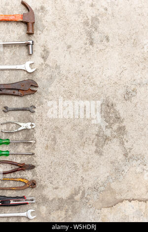 Many carftsman tools that are placed on the cement floor. Stock Photo