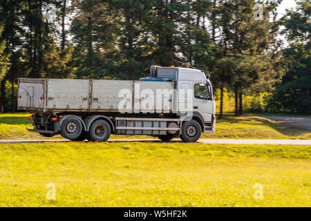 Big dump truck goes on country road Stock Photo