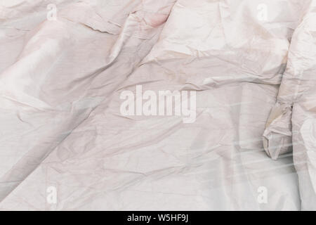 Wrinkled gray canvas that is in the water. Fabric crease background and texture. Stock Photo