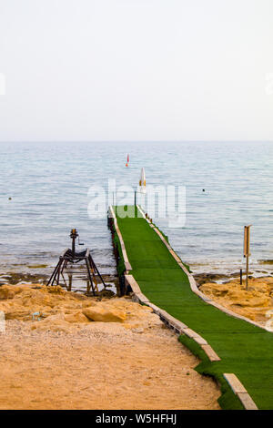 Plank footpath extending over calm water Stock Photo