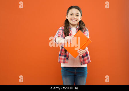 Did you know. Pupil with work book. Literature and writing lesson. Schoolgirl with notebook doing homework. Learning language. Studying is exciting. Girl cute kid study with book. Interesting book. Stock Photo