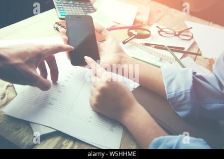 Team meting. phone,papers and different items   on the table Stock Photo