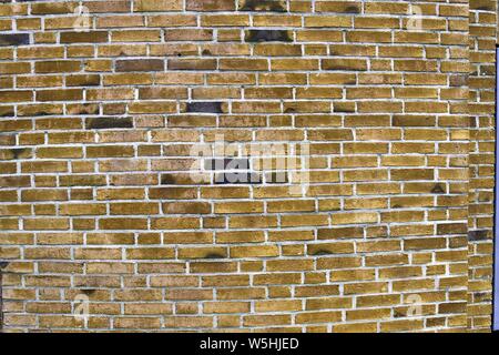 Detailed close up view on yellow colored old and weathered vintage brick walls in high resolution Stock Photo