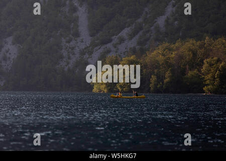 Couple paddling in a canoe, Lake bohinj, Slovenia, Europe Stock Photo