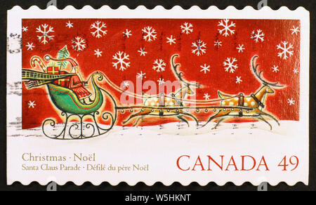 Santa Claus on sleigh pulled by reindeers, canadian postage stamp Stock Photo